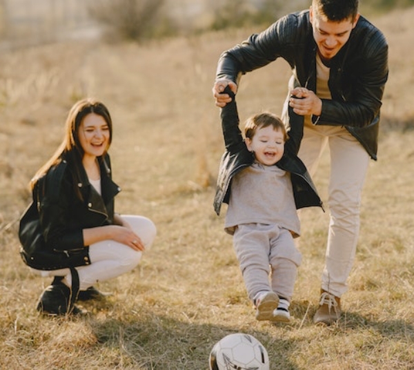 Parents playing with their son and a ball